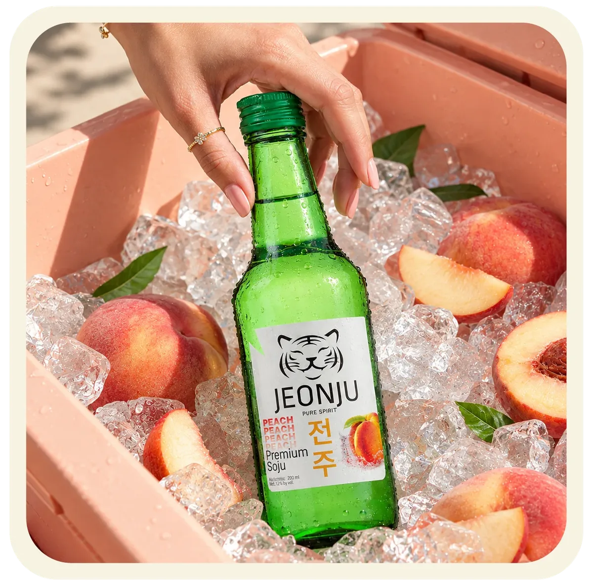 Jeonju Peach Soju bottle on ice beside peaches