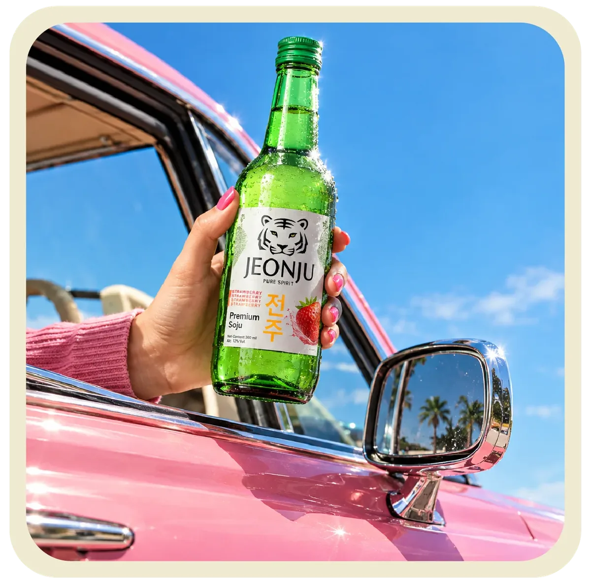 Jeonju Strawberry Soju bottle held beside a car mirror